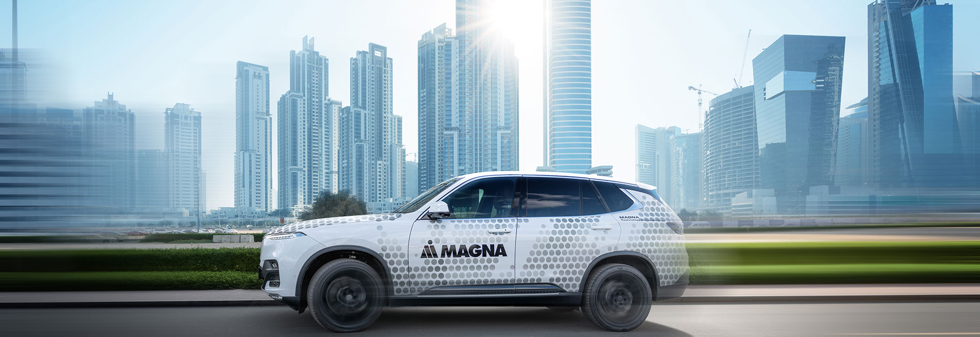 Magna Car is driving through a city
